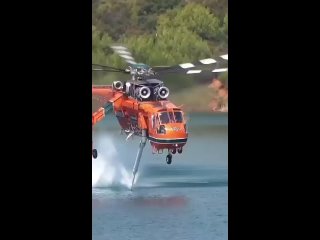 the new rescue helicopter for fire extinguishing takes water while in a fixed position in the air | @videfunny